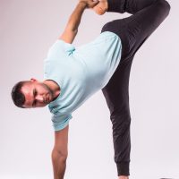 Concept of yoga. Handsome man doing yoga exercise isolated on a white background