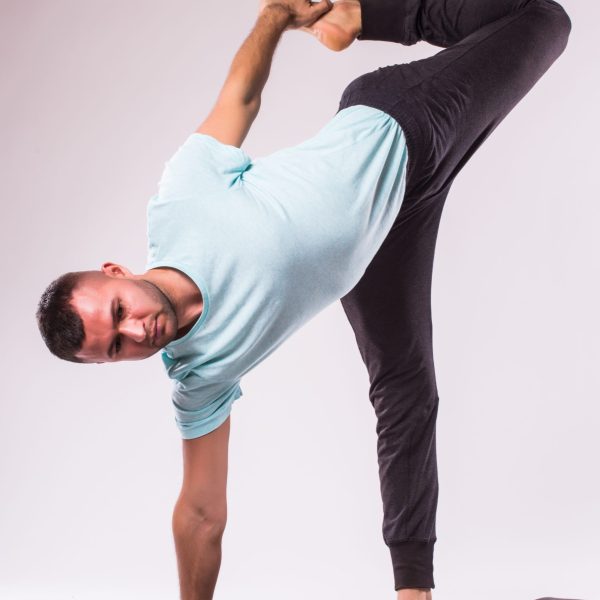 Concept of yoga. Handsome man doing yoga exercise isolated on a white background Concept of yoga. Handsome man doing yoga exercise isolated on a white background