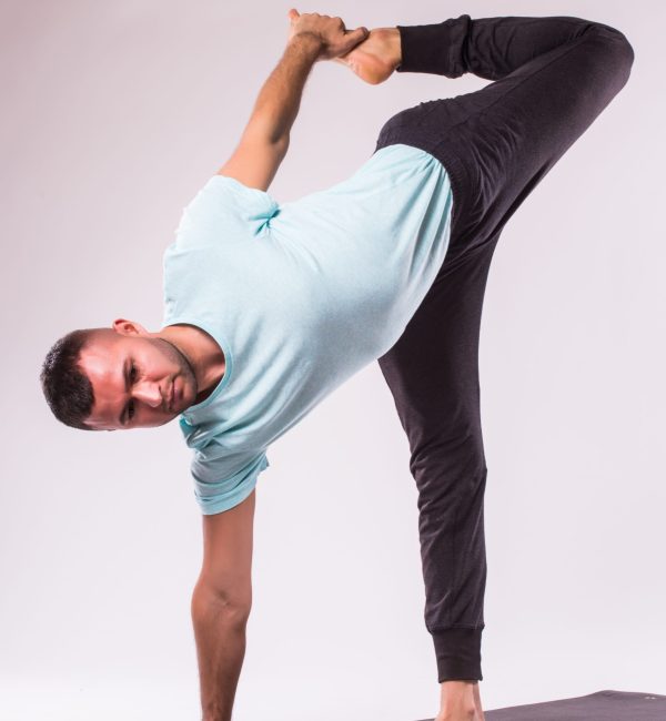 Concept of yoga. Handsome man doing yoga exercise isolated on a white background Concept of yoga. Handsome man doing yoga exercise isolated on a white background